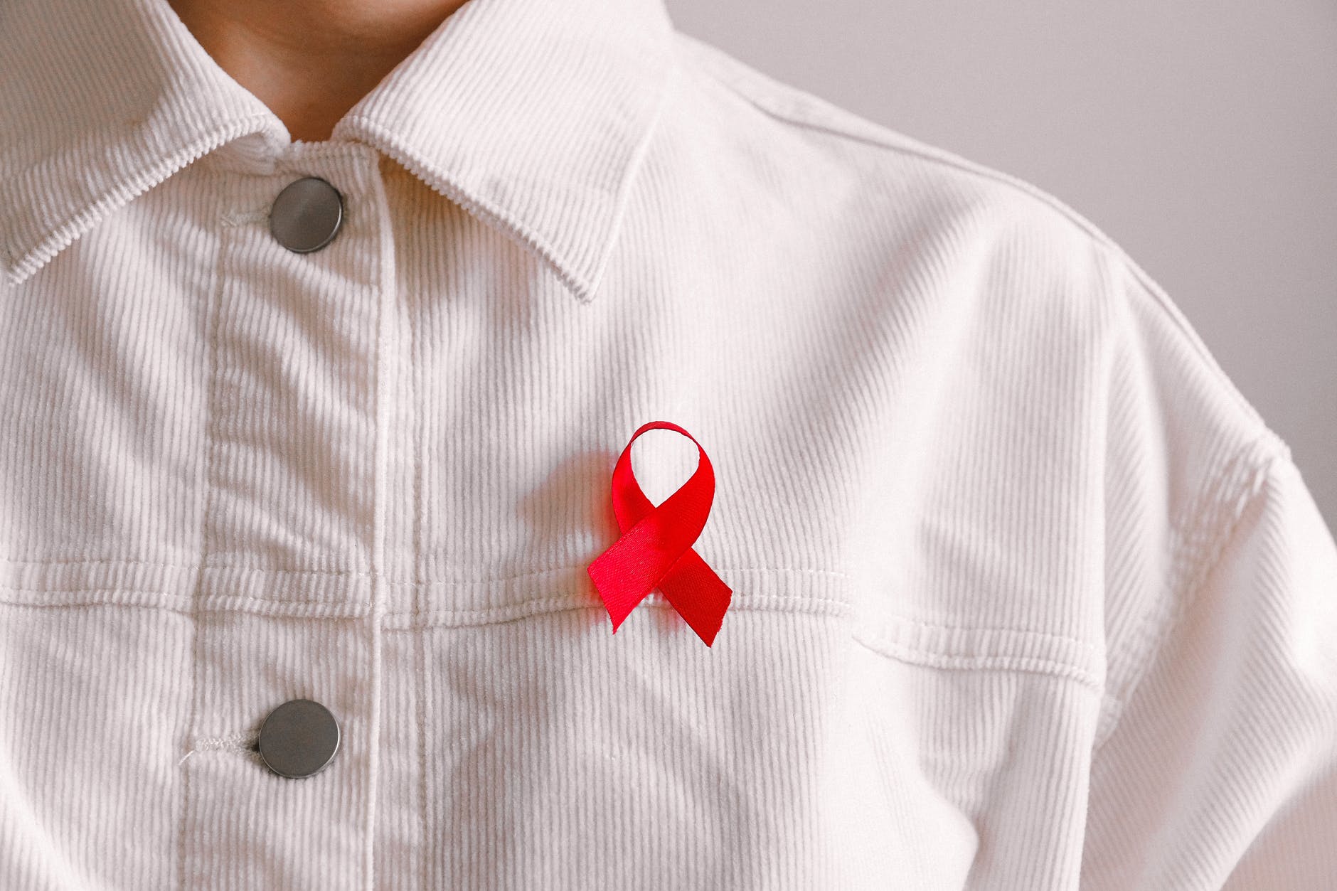 man wearing red ribbon