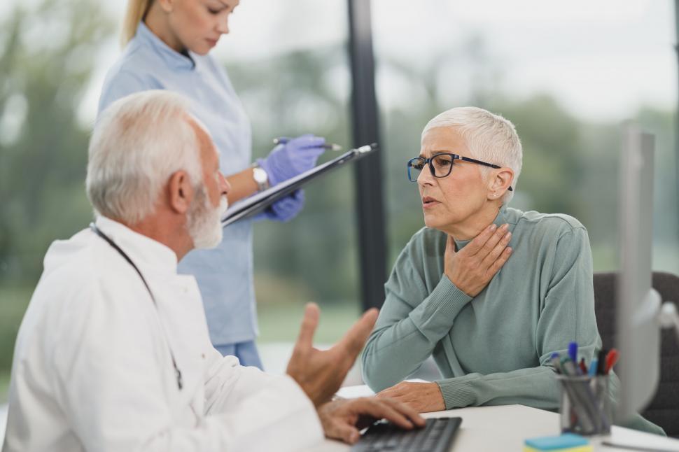 An elderly patient discussing her health concerns with her doctor.