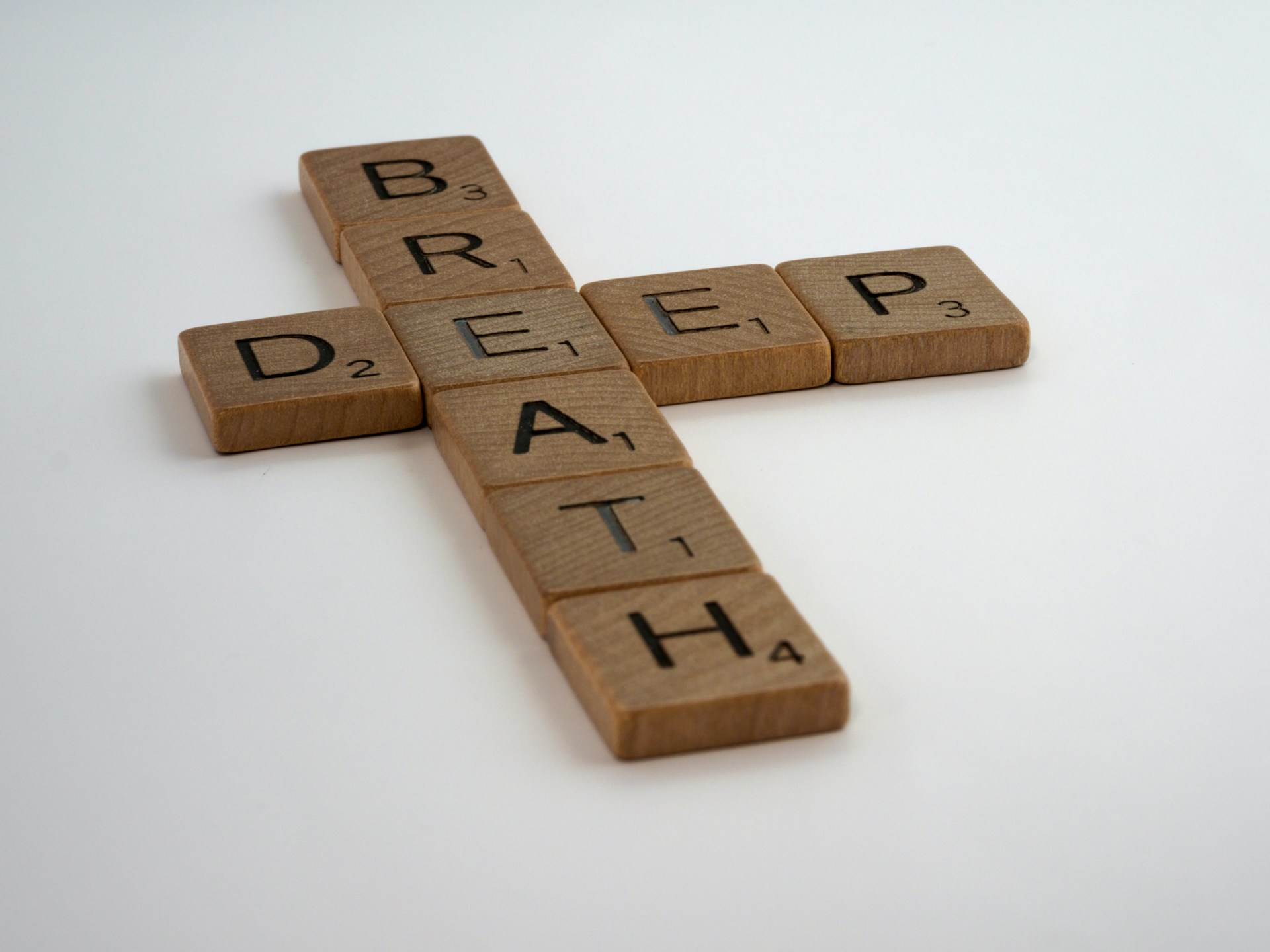 Scrabble tiles that spell "Deep Breath" by Brett Jordan from Unsplash