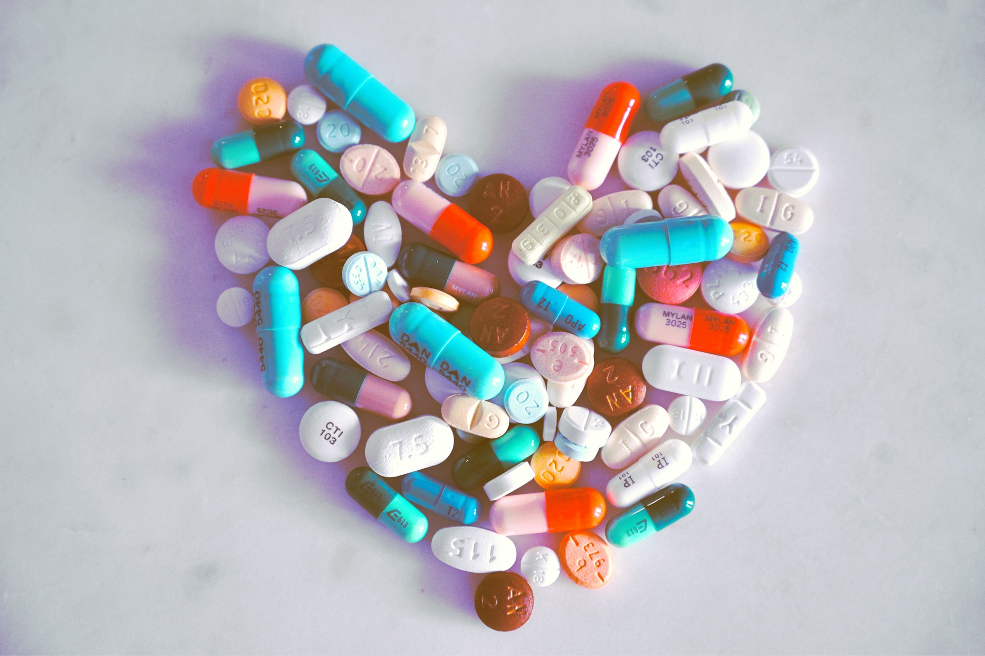 A pile of pills shaped into a heart by Madison Agardi, visualizing the care into developing therapeutics that help patients.